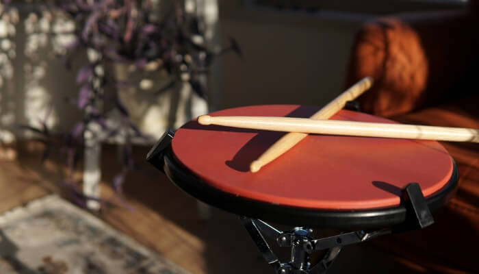 Wooden drumsticks on a practice pad